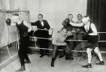 Two blindfolded boxers and a referee in a boxing ring, c. 1925